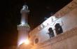 Grand Husseini mečetės minaretas vakaro tamsoje